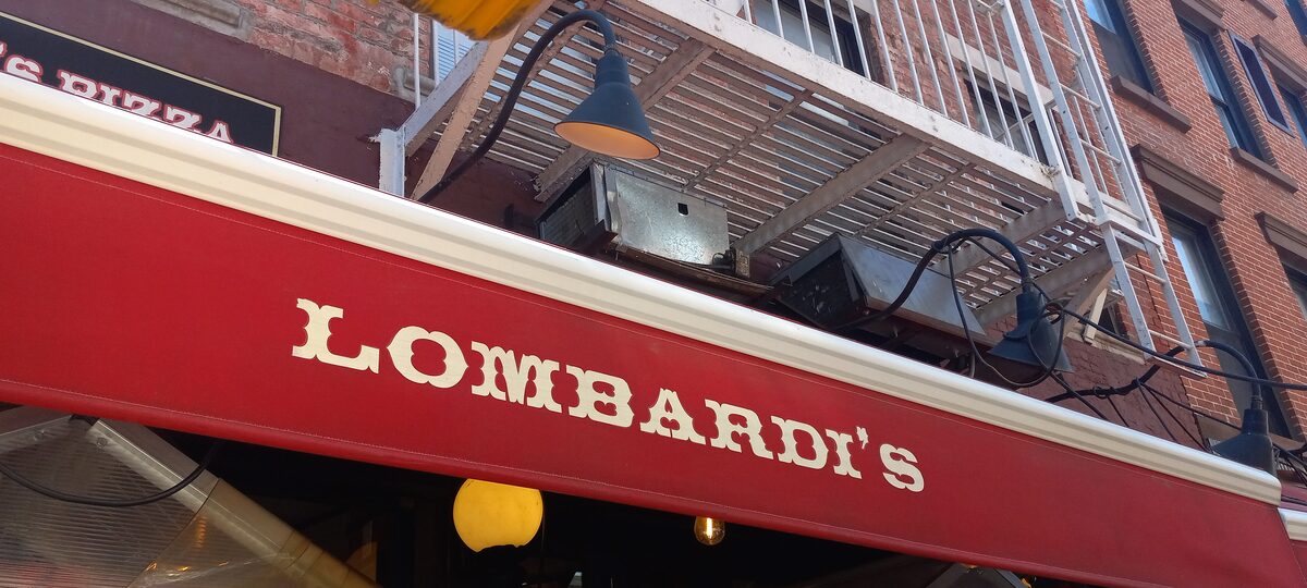 The red Lombardi's awning over the pizzeria entrance in Manhattan