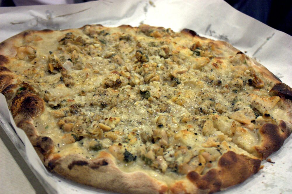 A white clam pie at Frank Pepe in New Haven, with a charred, blistered rim