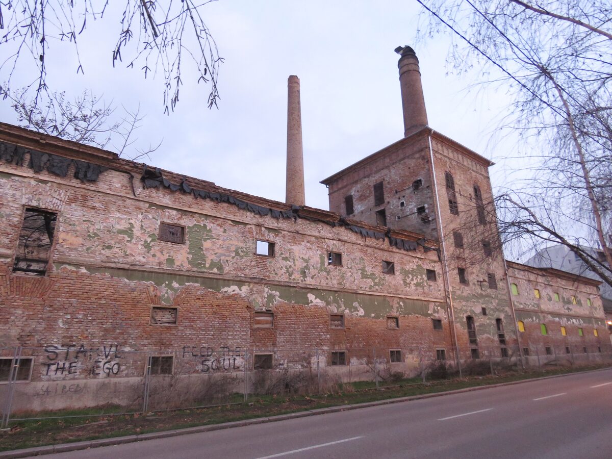 The abandoned brick building of the old Weifert brewery in Pančevo, with two tall chimneys