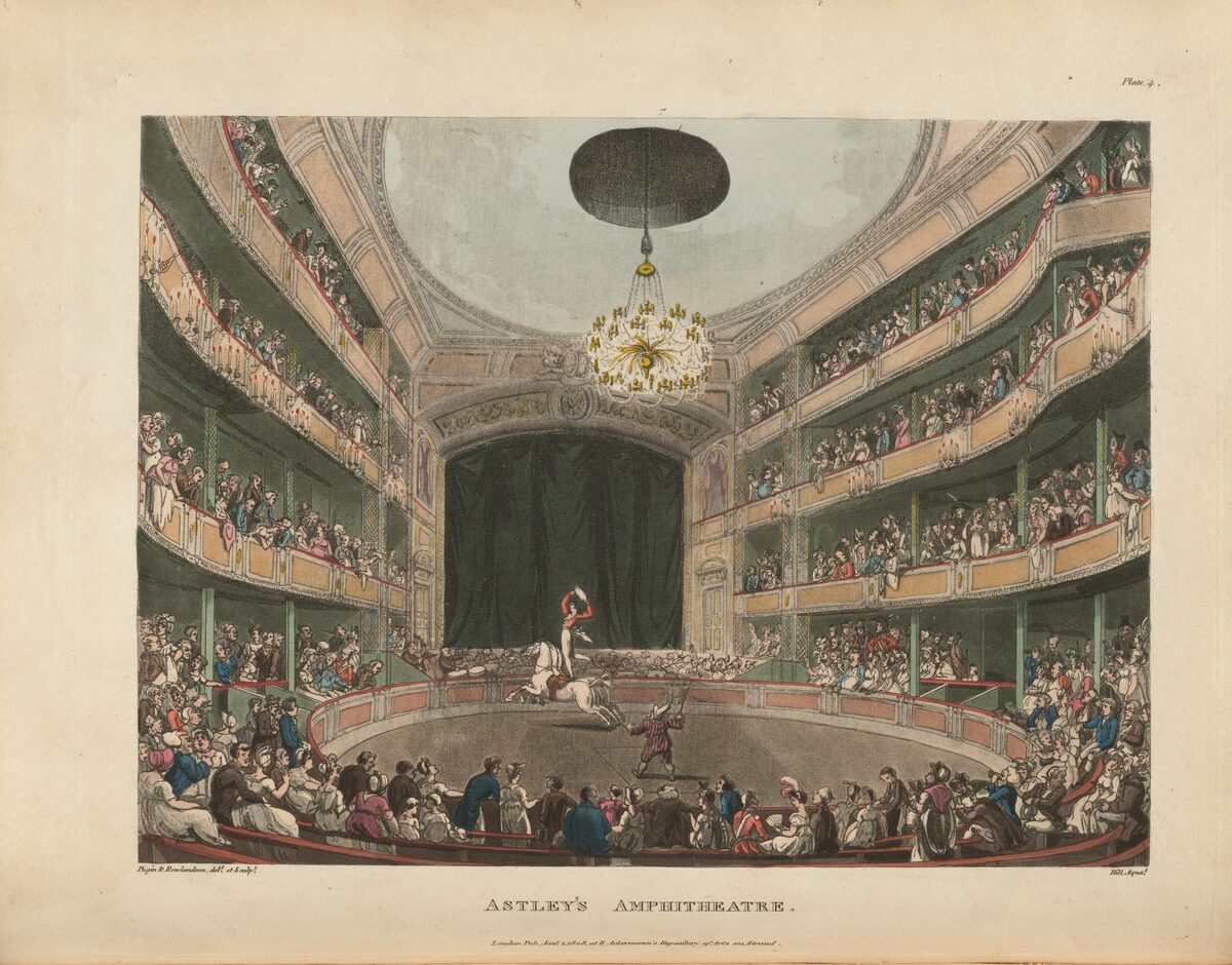 Colored 1808 print of Astley's Amphitheatre in London: a rider on horseback in the sawdust ring, packed galleries and a chandelier overhead