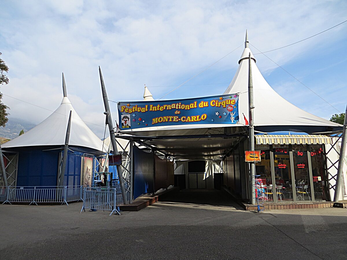 White and blue tent entrance under a banner for the Festival International du Cirque de Monte-Carlo, Monaco