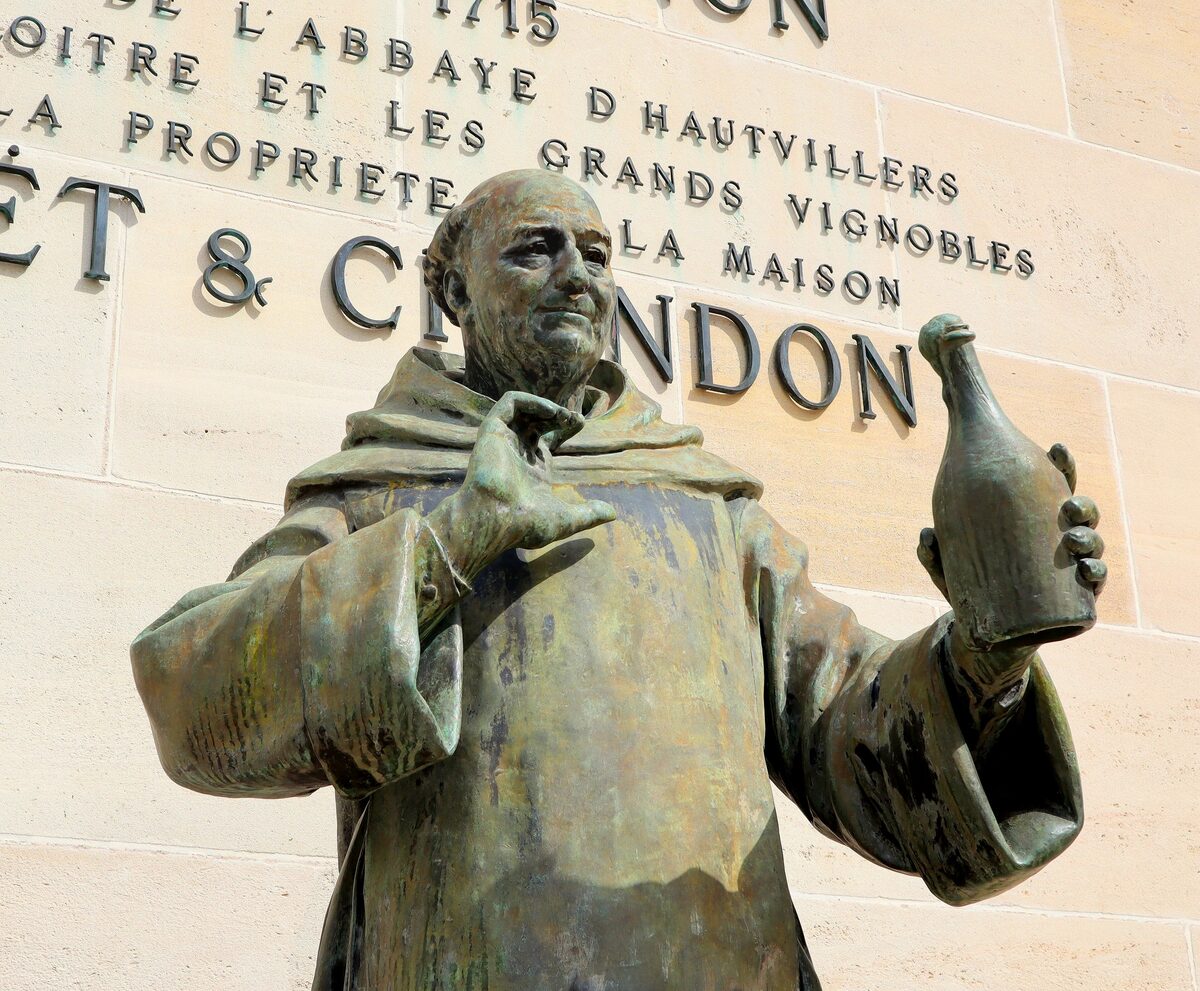 Bronze statue of the monk Dom Pérignon holding a bottle, on the Moët and Chandon wall in Épernay
