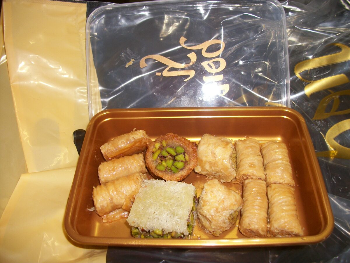 A box of assorted baklava from a Beirut pastry shop, with rolls, nests and pistachio pieces