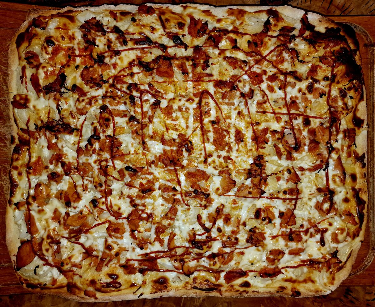 A baking-tray-size pizza paulista with pulled chicken and requeijao cheese