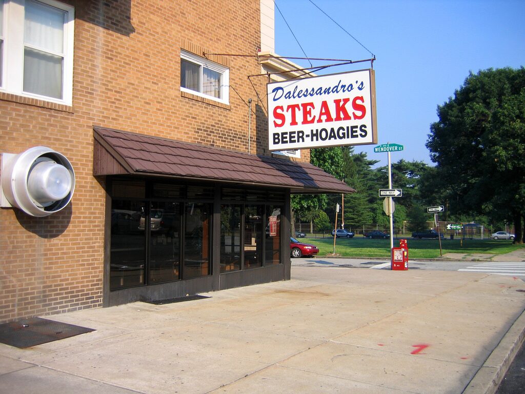 The brick storefront of Dalessandro's Steaks in Roxborough, with its Steaks, Beer, Hoagies sign