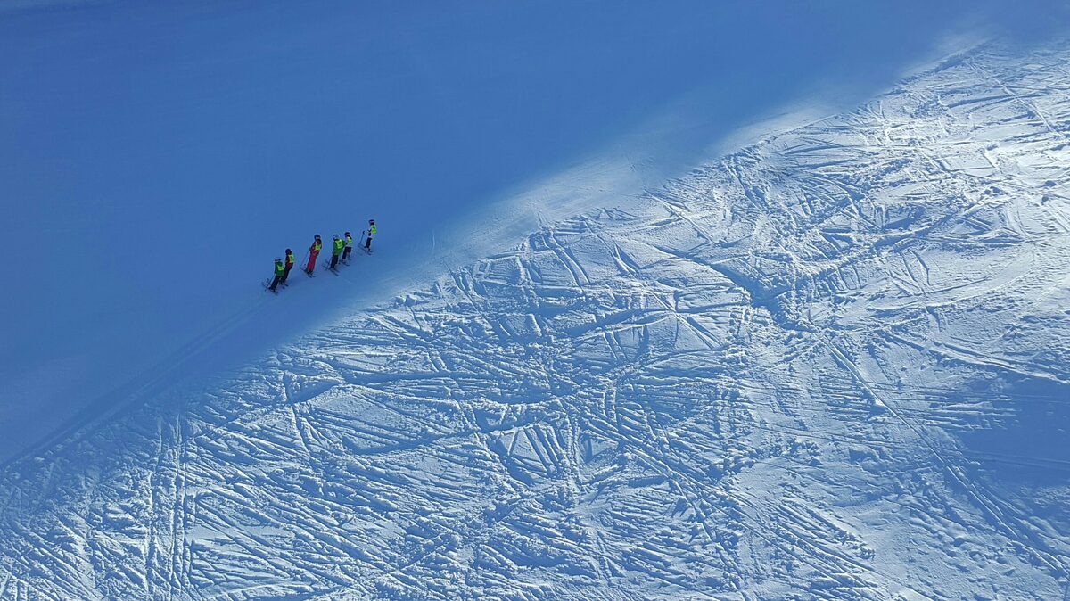 A ski school group on a snowy slope seen from above on Tornik, Zlatibor