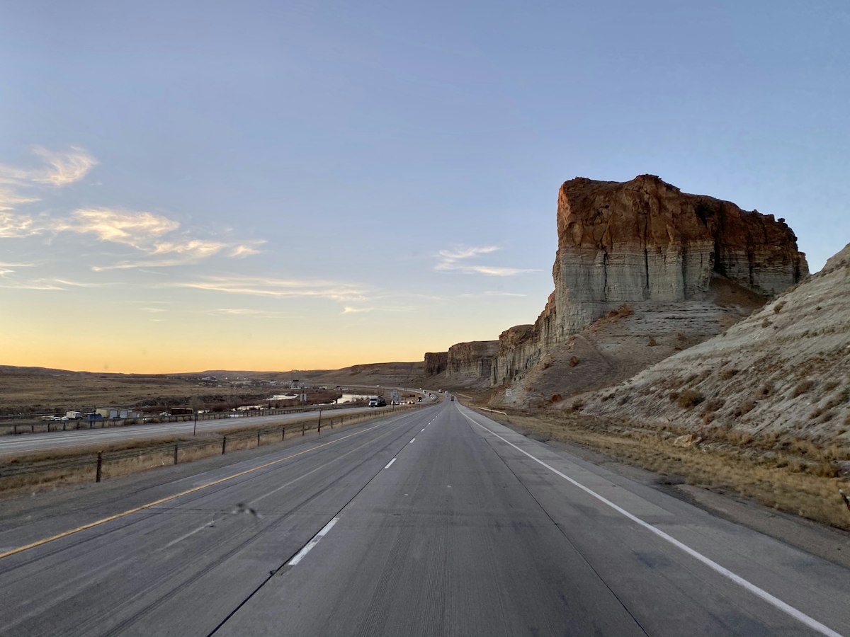 Interstate 80 westbound at Green River, Wyoming, with a sandstone butte beside the road