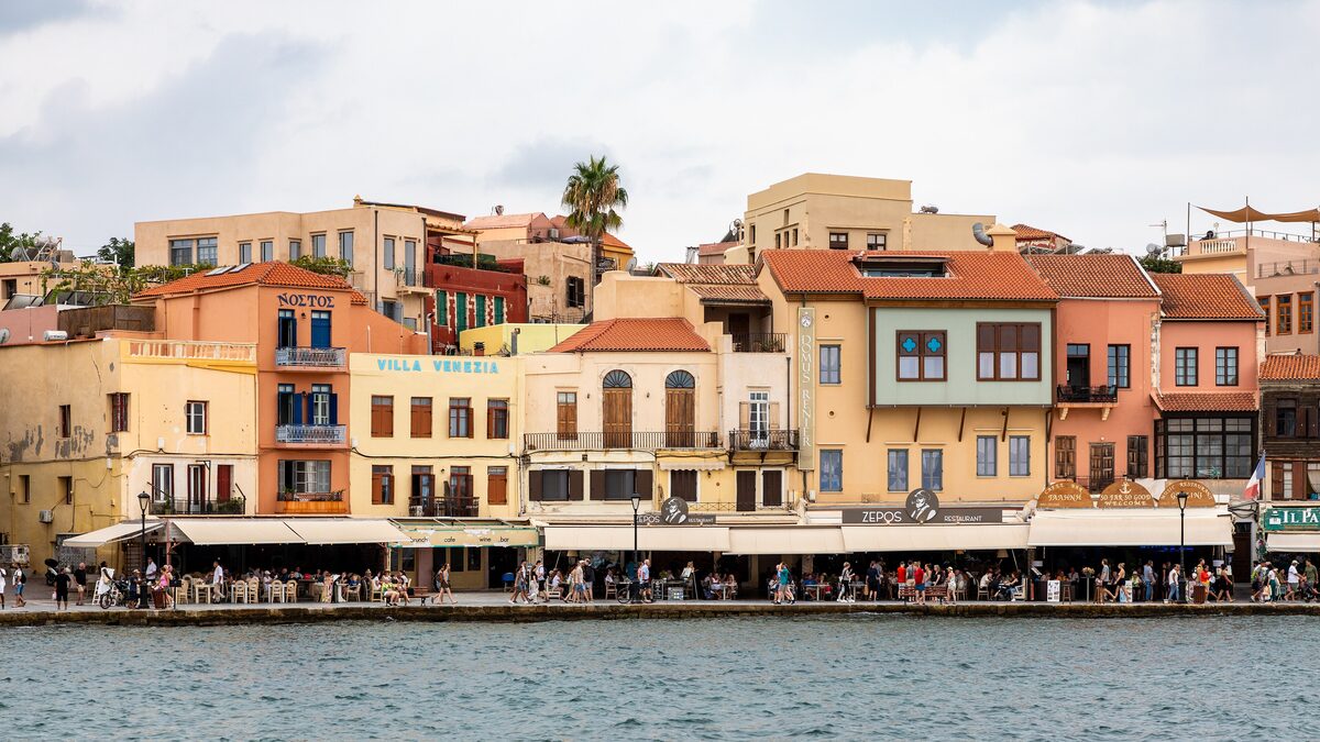 Pastel Venetian houses and harbourside tavernas on the old harbour of Chania, Crete