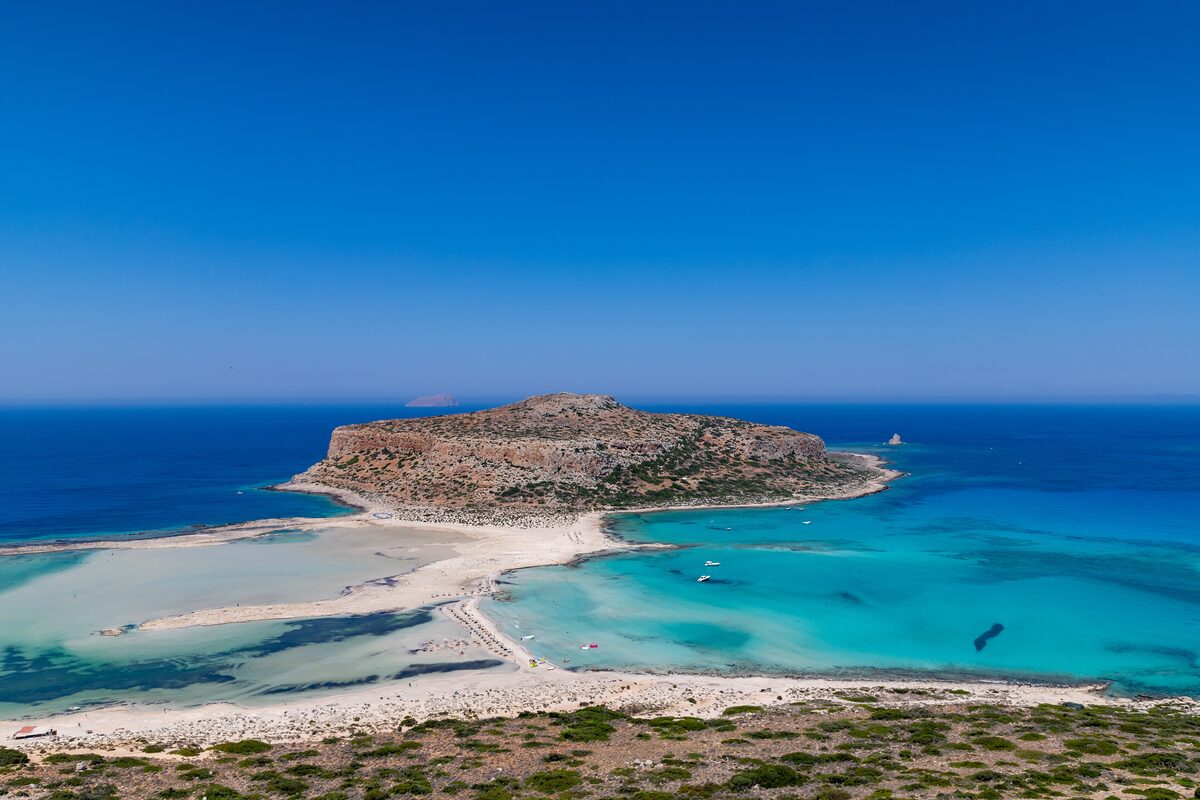 Aerial view of the Balos lagoon on Crete, white sand and turquoise shallows below the Gramvousa peninsula
