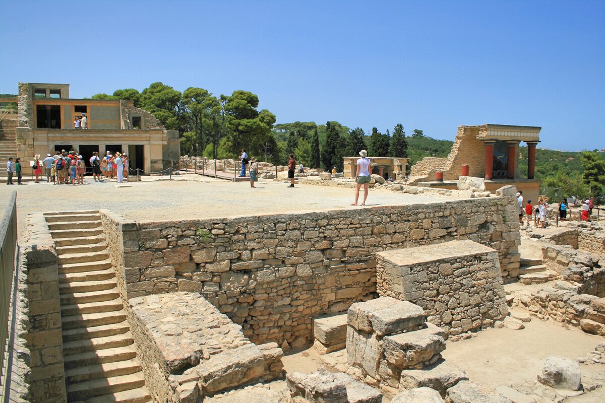 The central court of the Minoan palace of Knossos on Crete, with a restored colonnade and reconstructed red columns