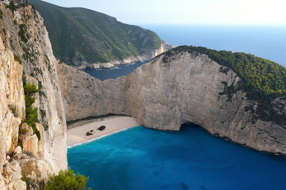 The Navagio shipwreck cove on Zakynthos, a white sand beach below limestone cliffs and deep blue water