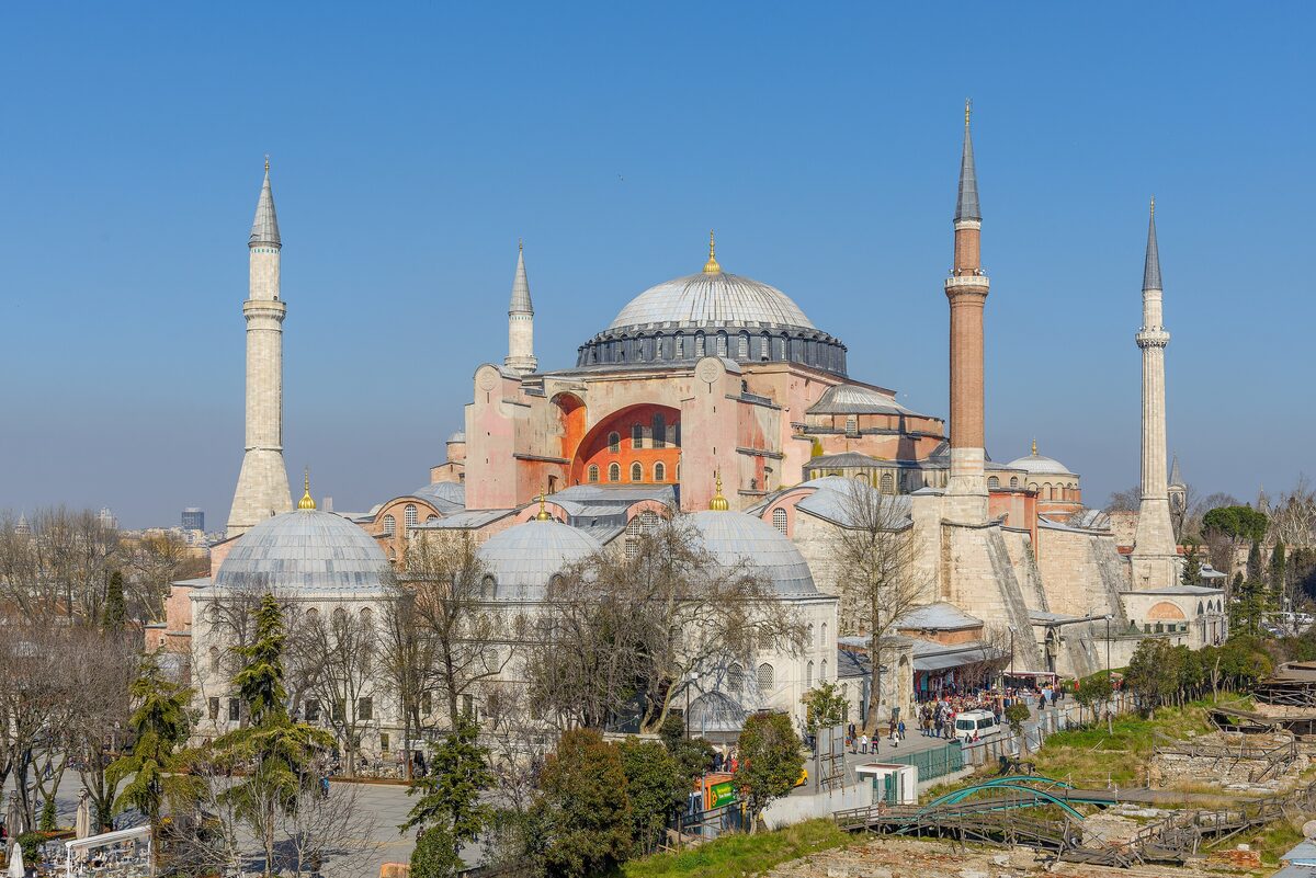 Hagia Sophia in Istanbul, a large dome with four minarets under a clear blue sky