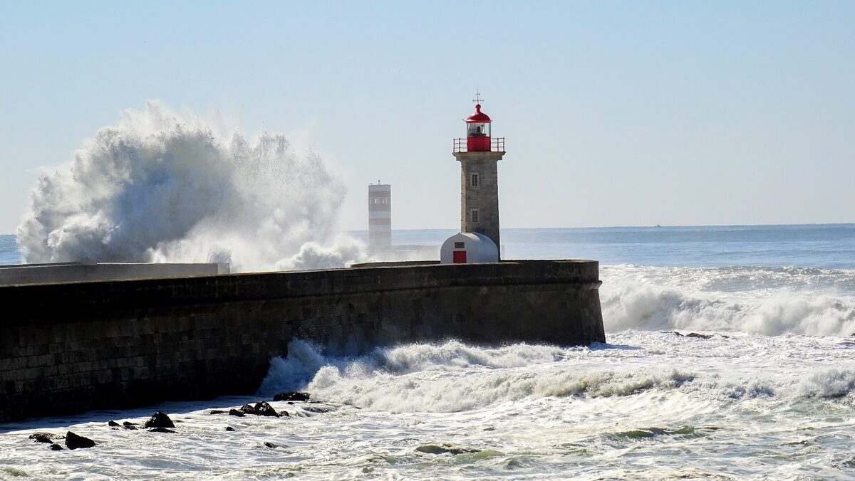 Waves breaking over the pier below the Felgueiras lighthouse at Foz do Douro, where the Douro meets the Atlantic