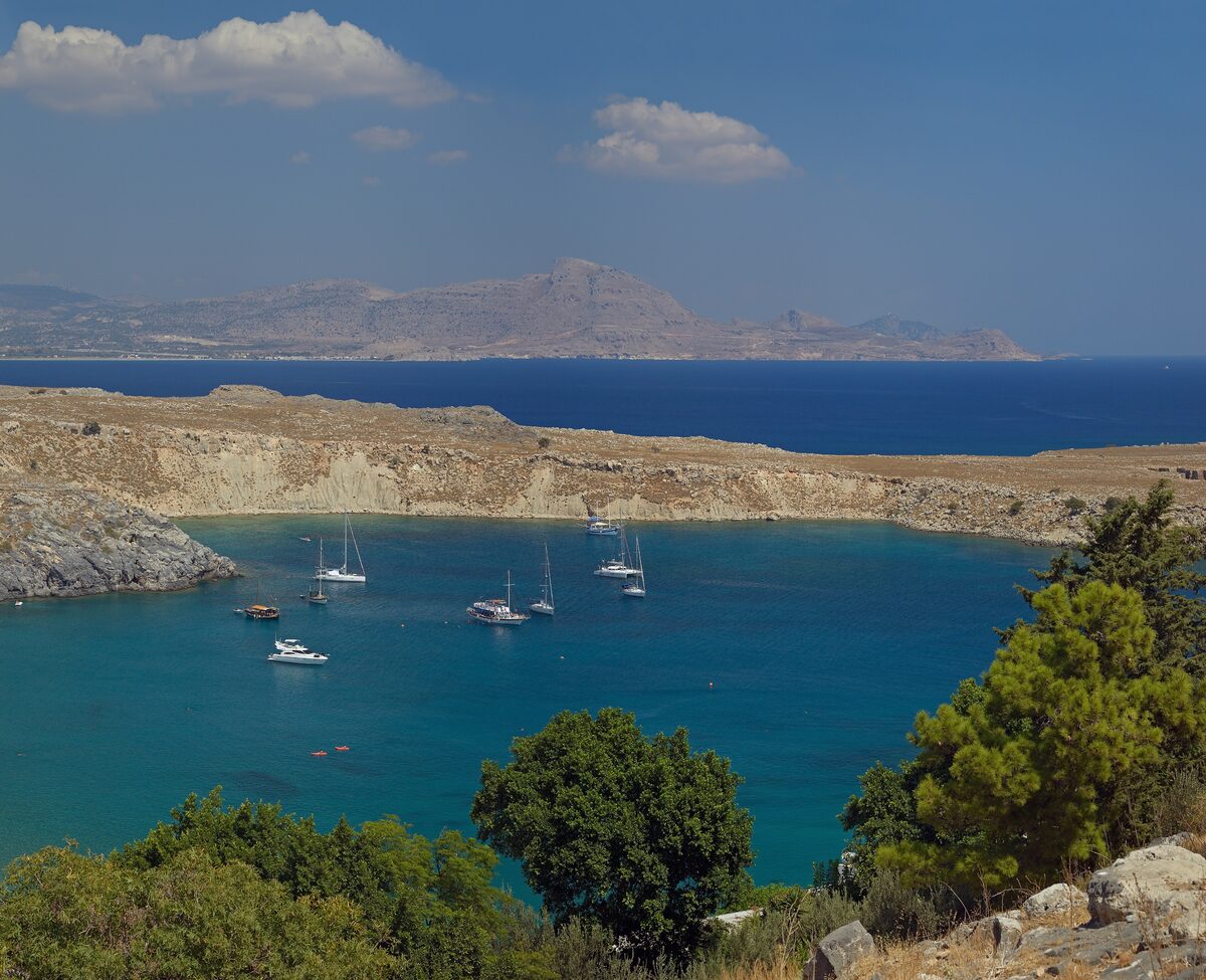 Boats anchored in the turquoise water of St Paul's Bay near Lindos, Rhodes