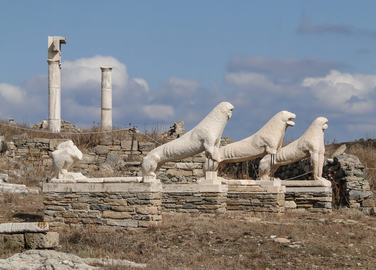 The marble lions of the Terrace of the Lions on Delos, with ruined columns behind