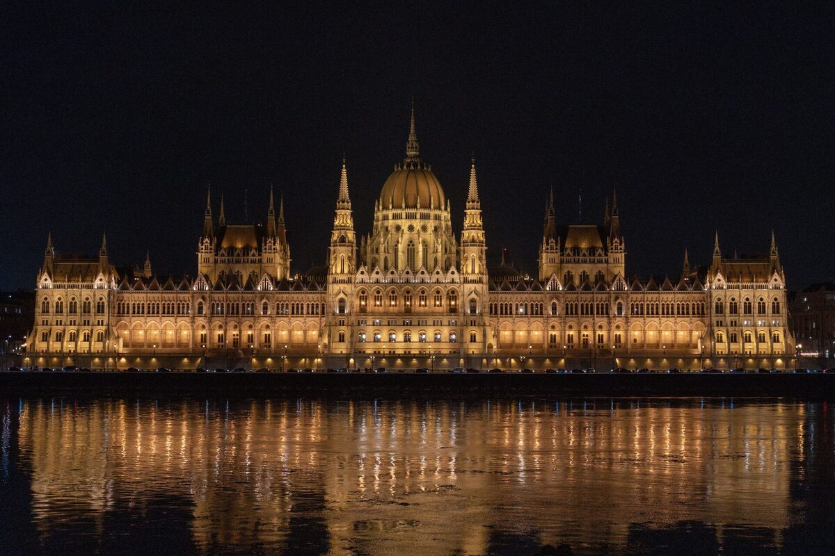 The Hungarian Parliament lit up at night and reflected in the Danube in Budapest