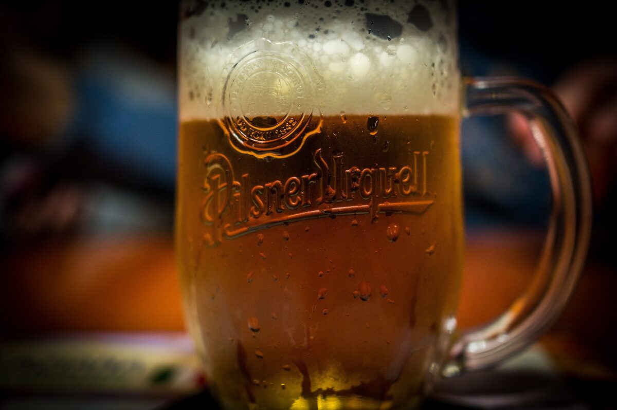 A mug of Pilsner Urquell with a foam head, the Czech lager that defines a Prague pub