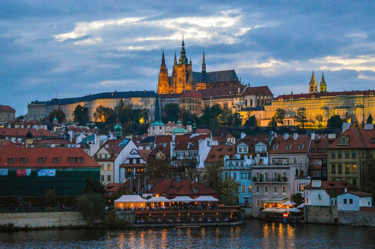 Prague Castle and the Malá Strana rooftops above the Vltava at dusk
