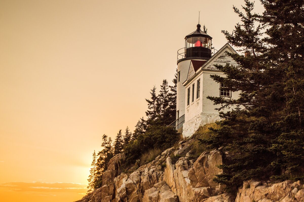Bass Harbor Head Light on its granite bluff at golden sunset