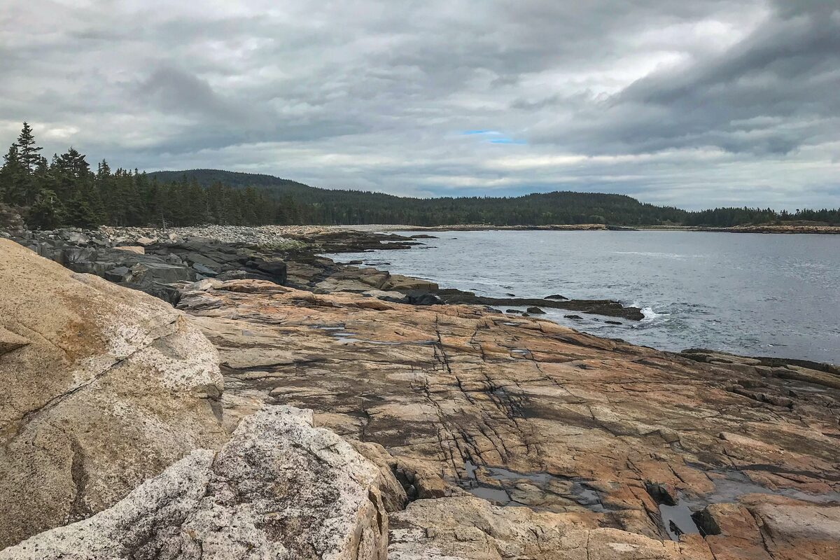 Pink granite ledges along the Schoodic Point shoreline under clouds