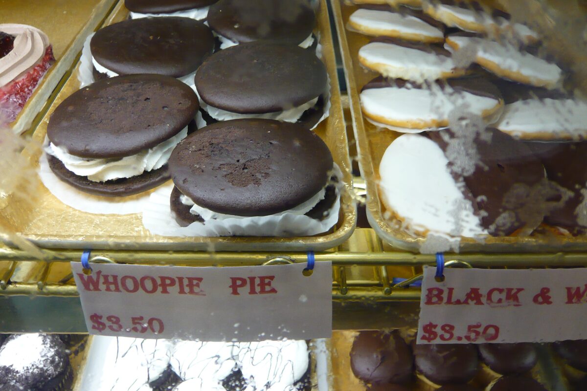 Chocolate whoopie pies with cream filling in a bakery case