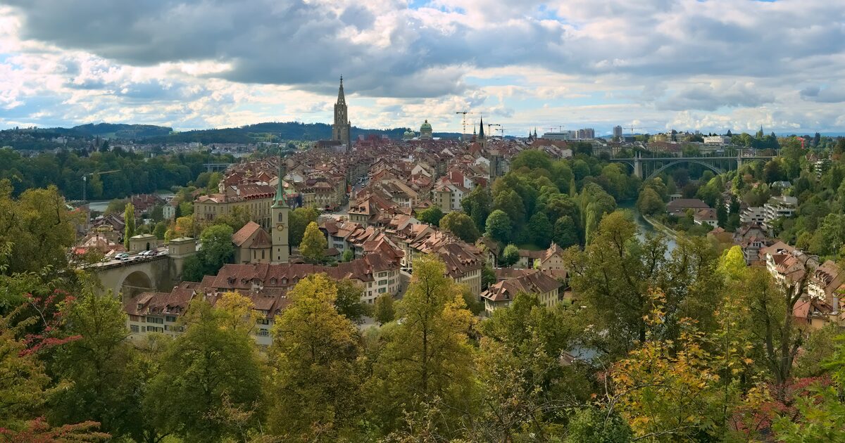 The old town of Bern on its peninsula in a bend of the Aare, with the Minster tower rising above red roofs