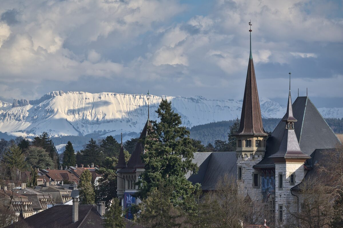 The Bernisches Historisches Museum with its pointed towers, and snow-covered Alps above the roofs