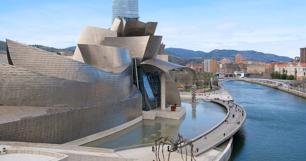 The titanium curves of the Guggenheim Museum Bilbao beside the Nervión River