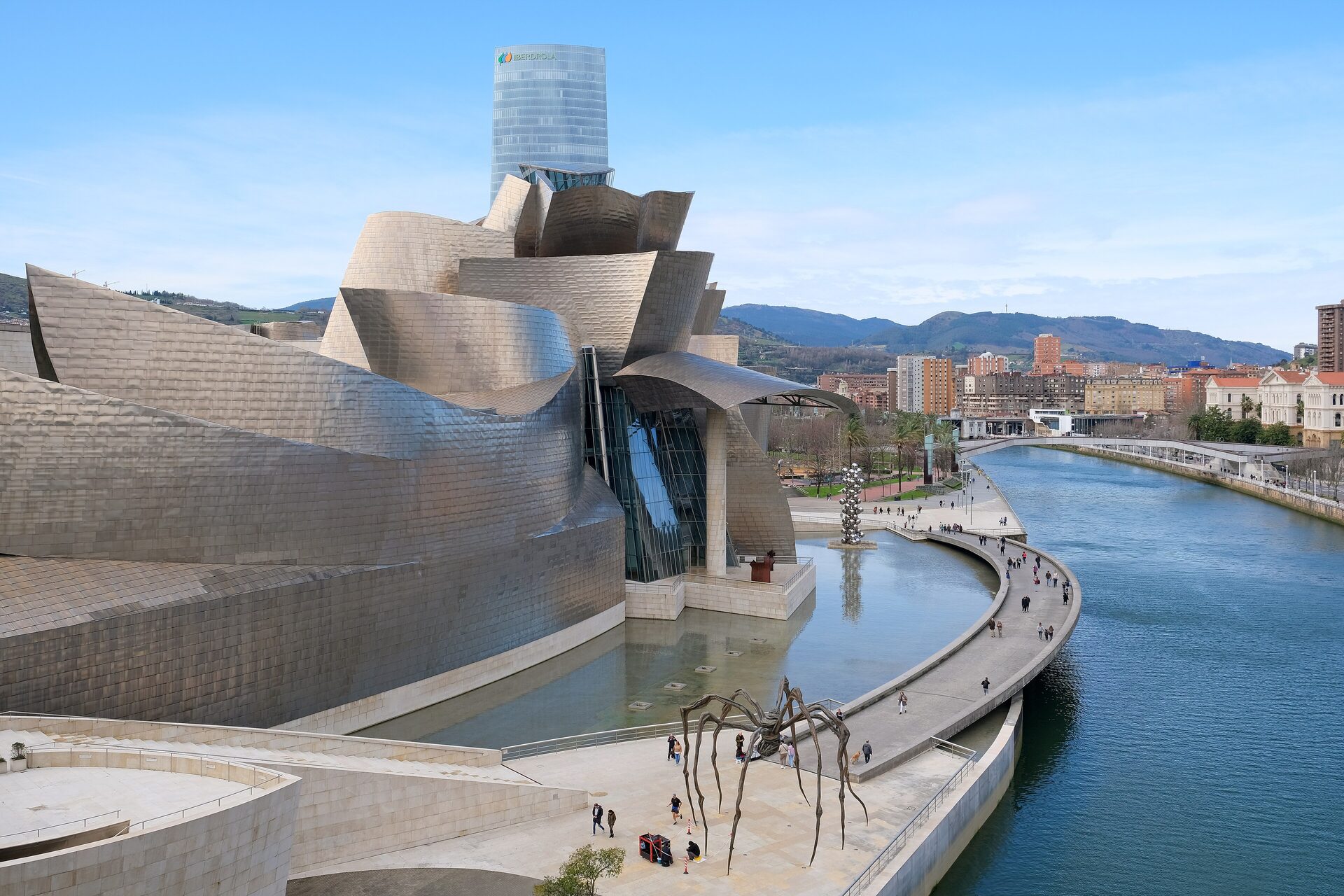 The titanium curves of the Guggenheim Museum Bilbao beside the Nervión River