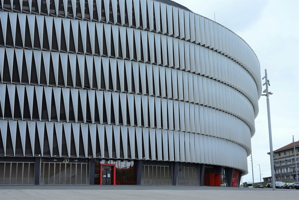 The curved, sawtooth-clad facade of the San Mamés stadium