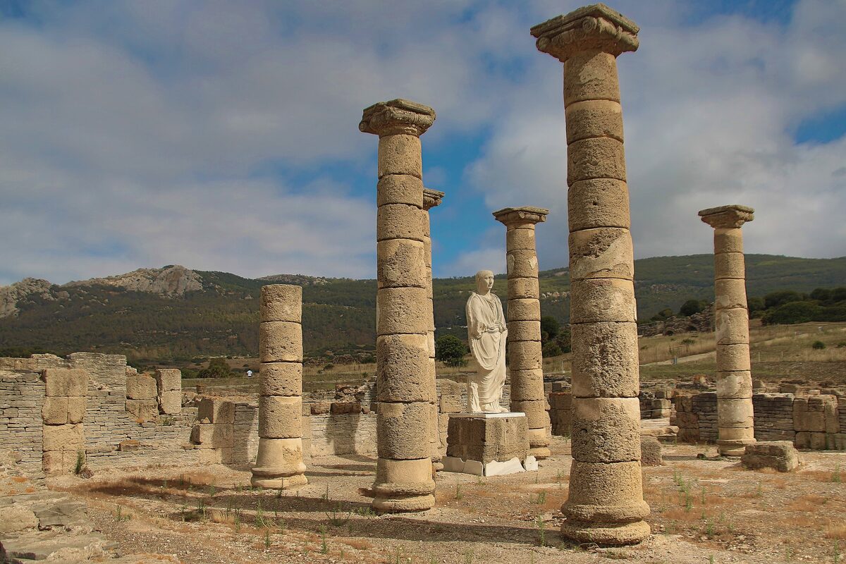 Columns and a statue among the Roman ruins of Baelo Claudia