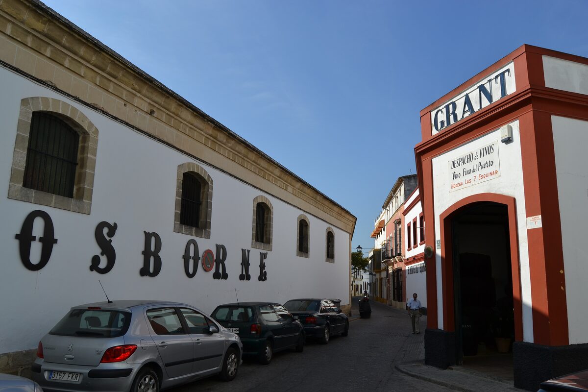 The Osborne sherry bodega and a red Grant gateway on a street in El Puerto