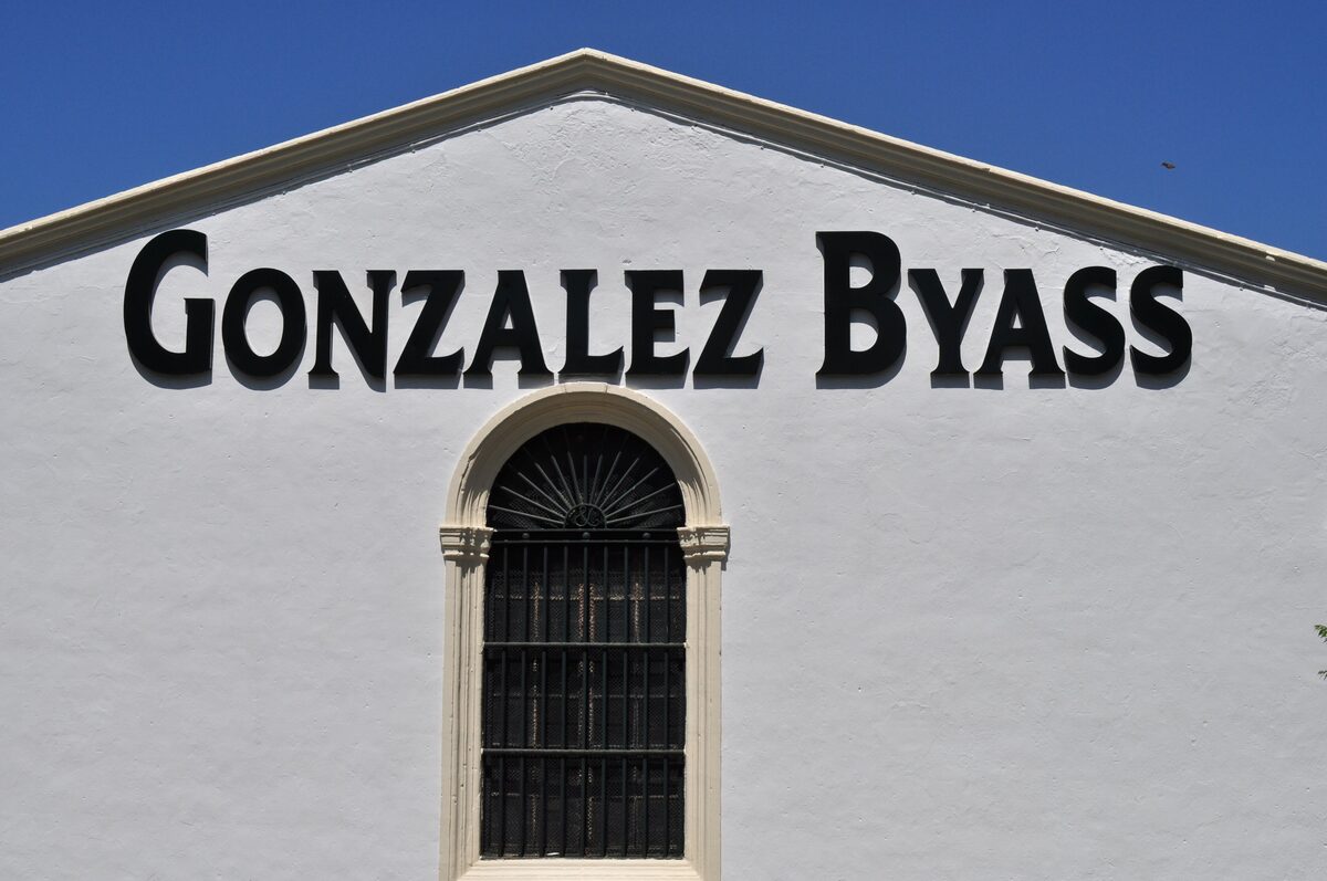 The white front of the González Byass bodega, with its name above an arched window