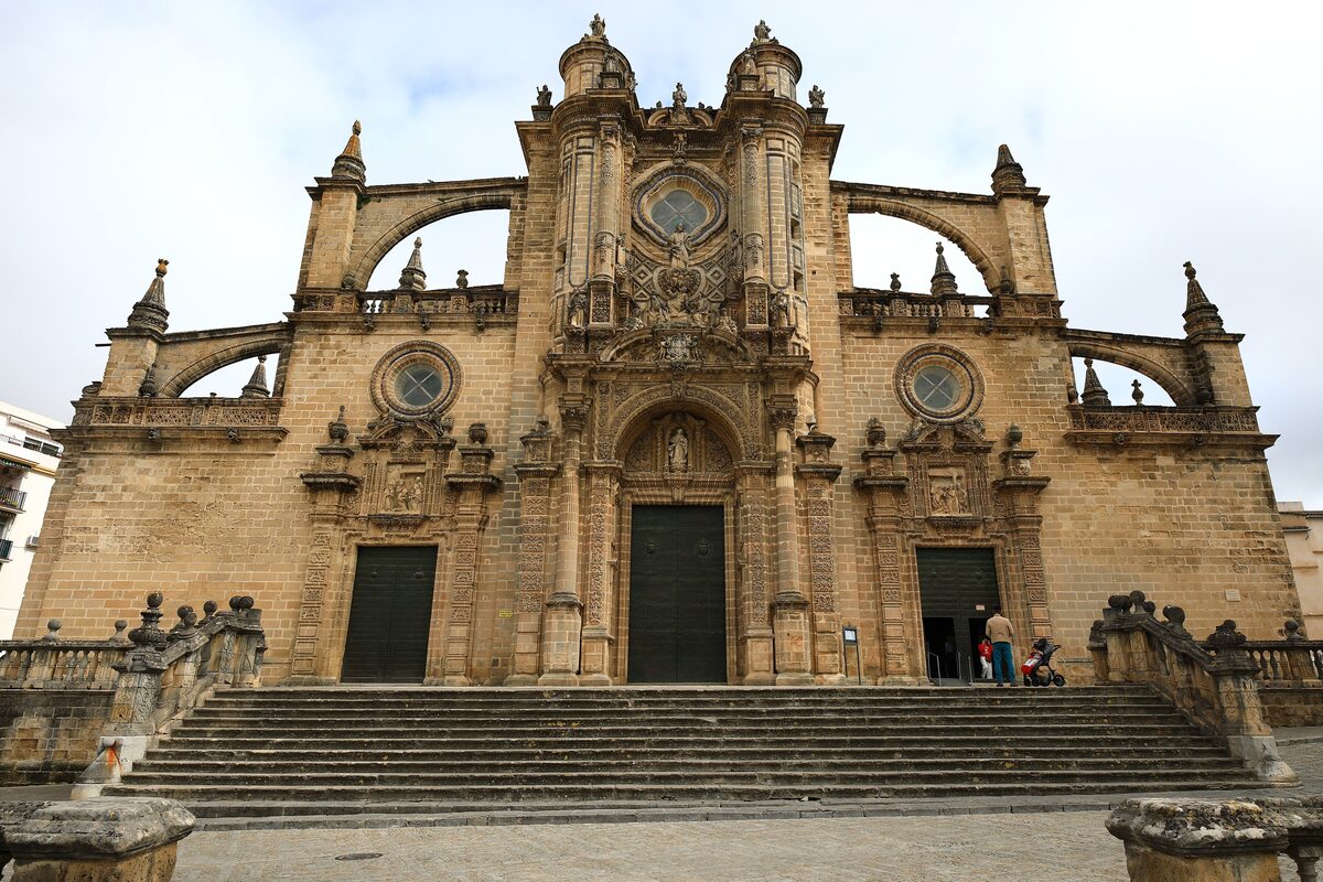 The stone facade of Jerez Cathedral above its wide stairway, in daylight