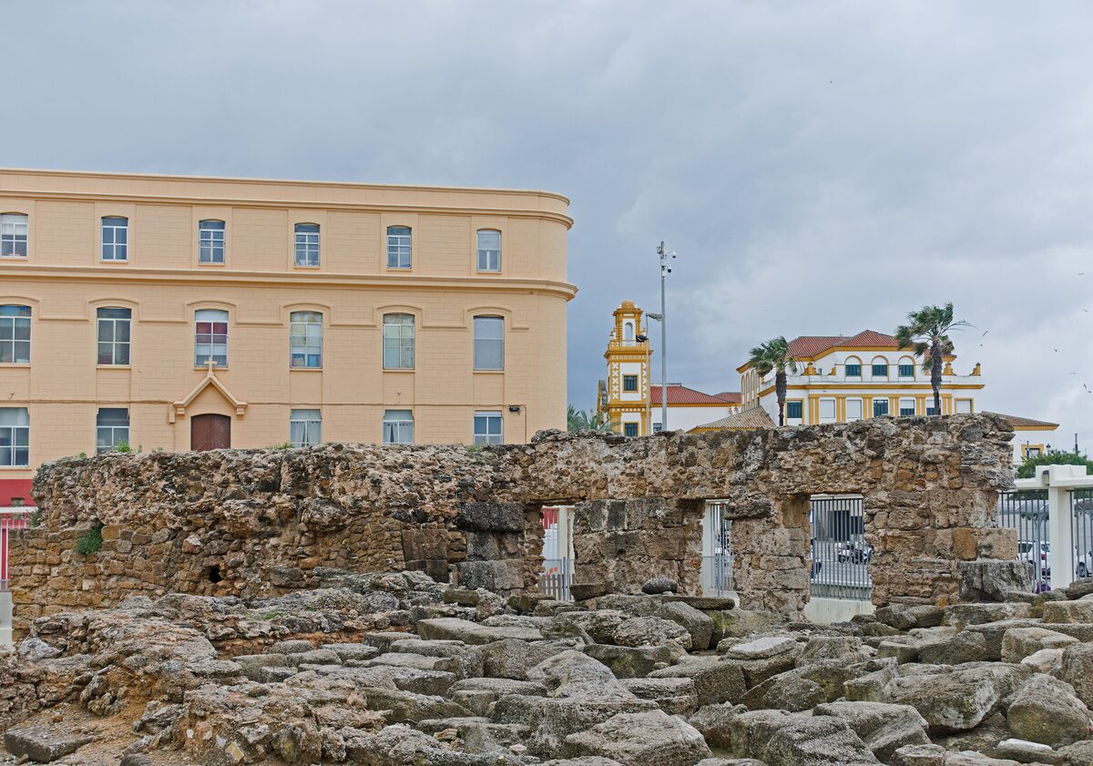 Roman ruins of the Teatro Romano, with the old town's houses behind