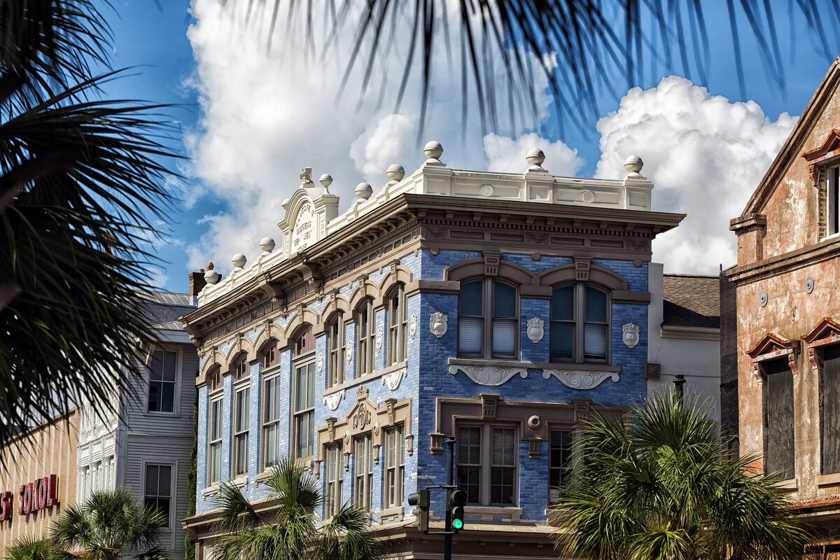 Ornate blue-tiled building on King Street among palm trees