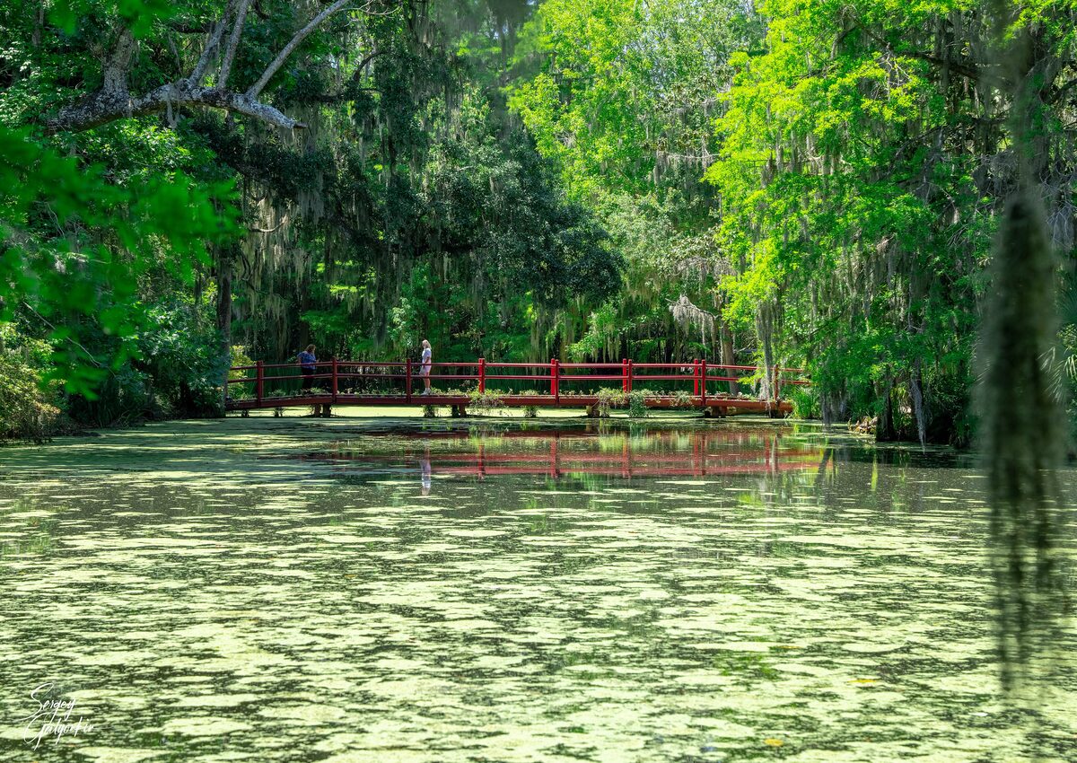 Red footbridge in the gardens of Magnolia Plantation