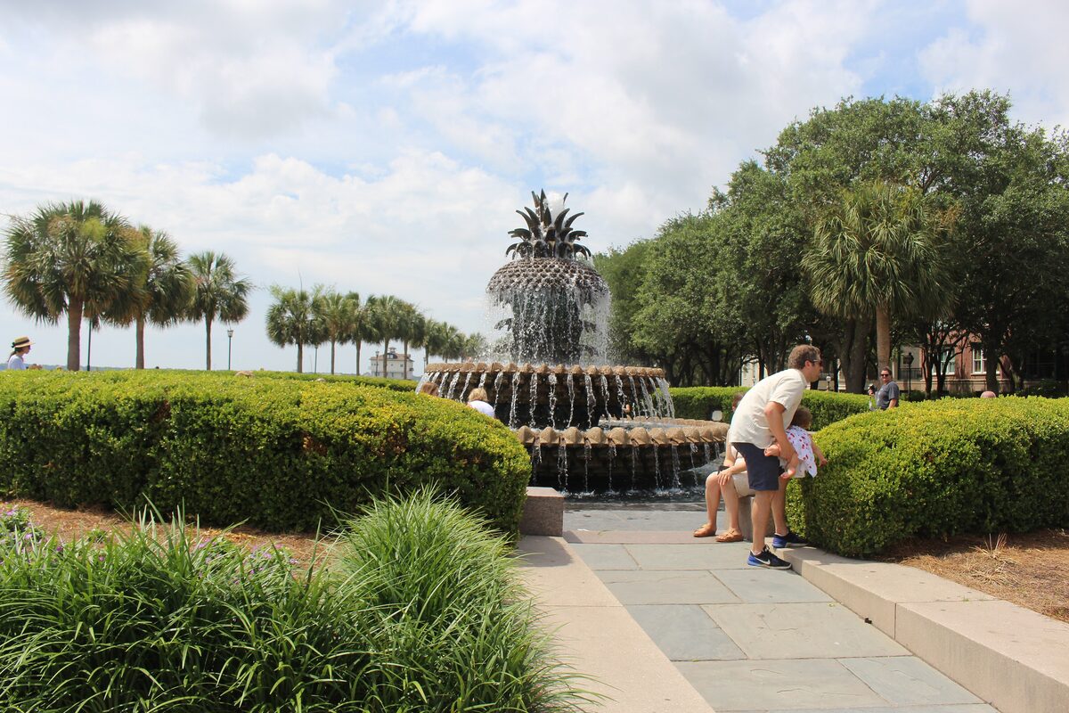 Pineapple Fountain behind clipped hedges in Waterfront Park