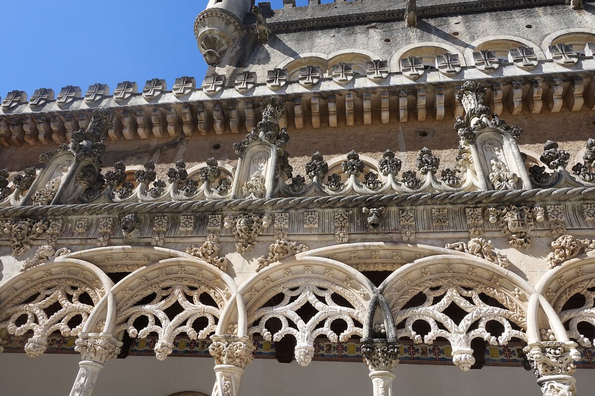 Carved stone balustrade and arches with openwork decoration on the facade of the Buçaco Palace hotel