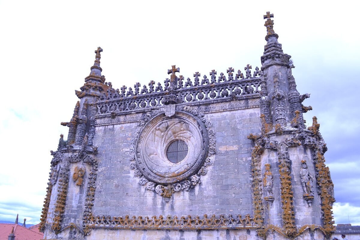 The Manueline facade of the Convent of Christ in Tomar, with its large carved rose window and pinnacles