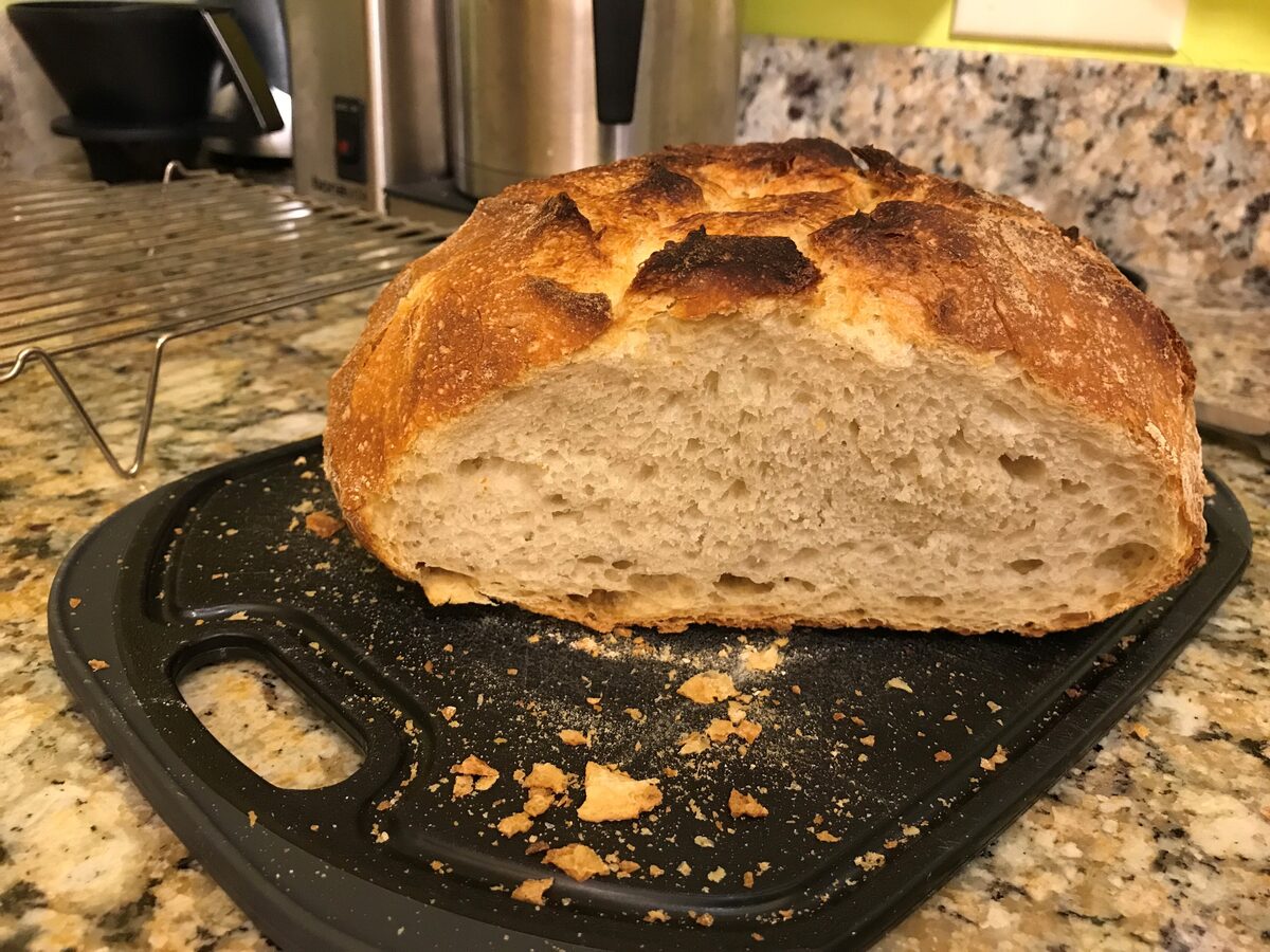 A crusty sourdough loaf cut open to show the crumb