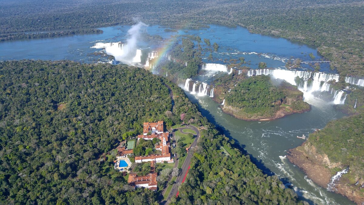 The Belmond Hotel das Cataratas from the air, set in the forest beside the falls