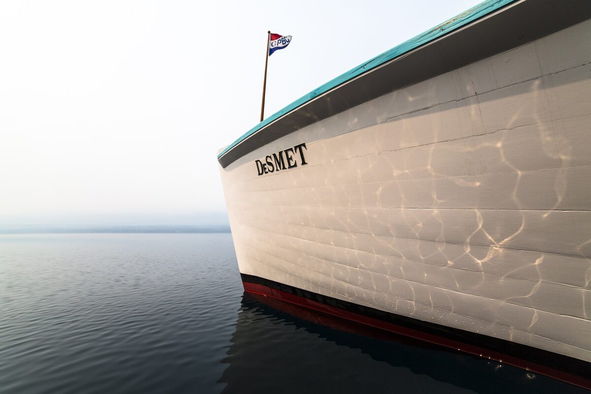 Bow of the DeSmet tour boat on calm Lake McDonald