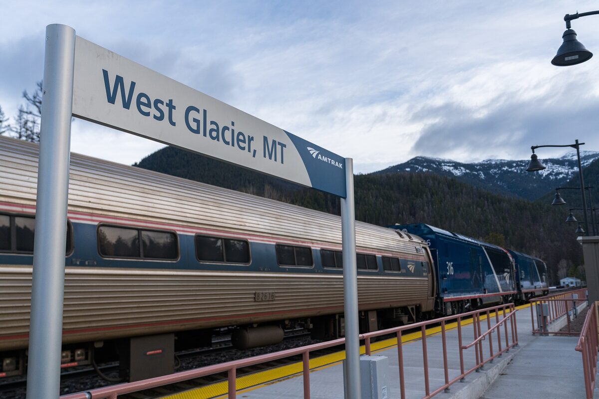 Amtrak train beside the West Glacier station sign