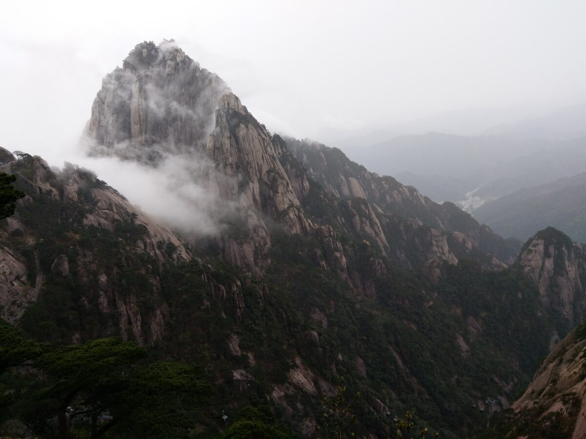 The granite summit of Tiandu Peak with cloud drifting over its slopes