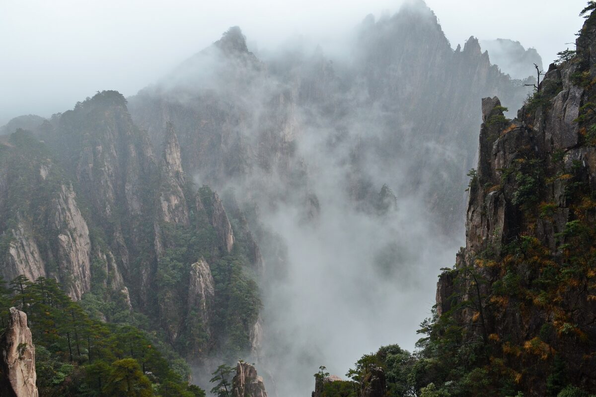 Mist drifting between steep granite pinnacles in the West Sea Grand Canyon