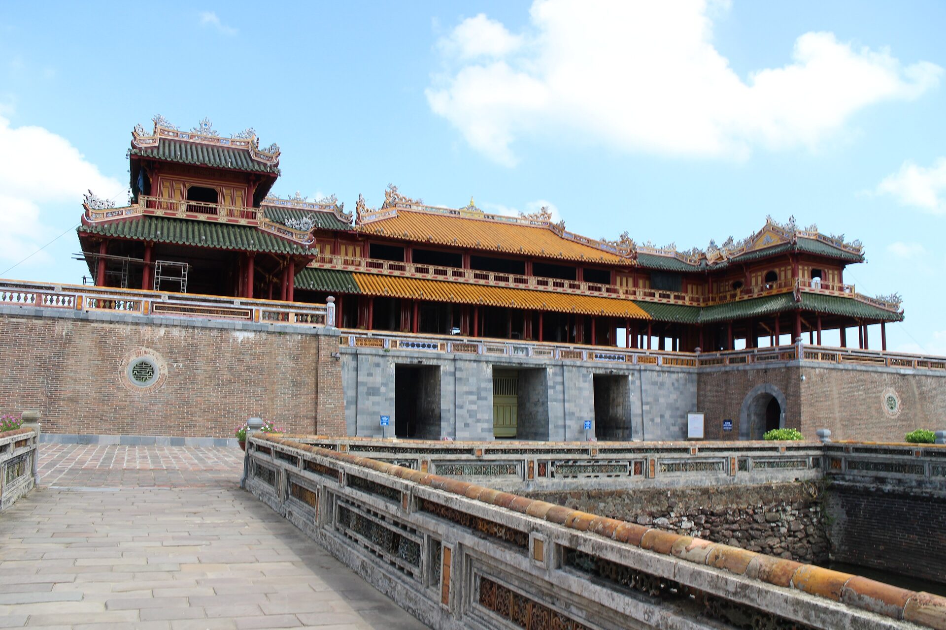 The Ngo Mon Gate of the Hue Imperial City under a blue sky, its yellow-roofed pavilion above the main gate