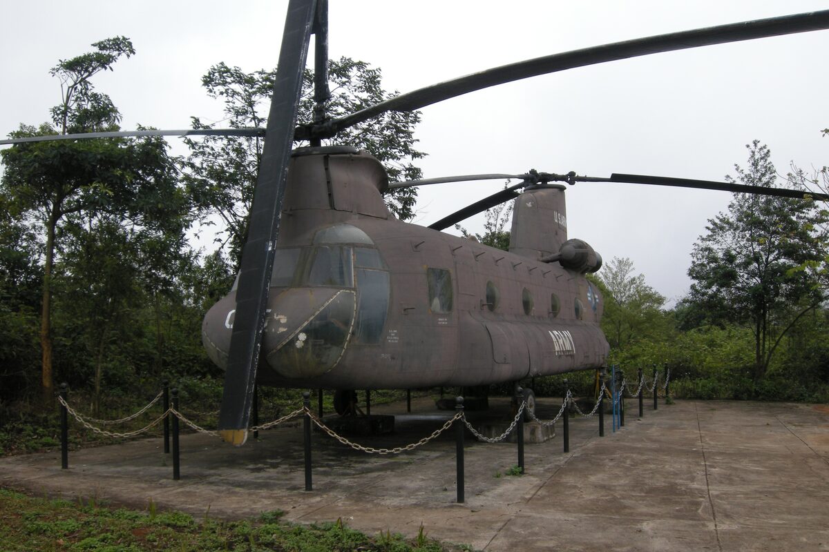 A CH-47 Chinook helicopter on display among trees at the Khe Sanh Combat Base museum