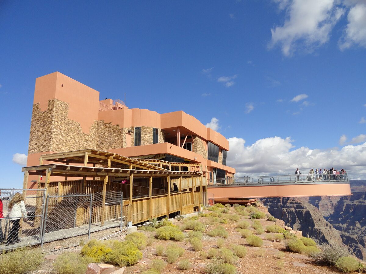 The horseshoe-shaped glass Skywalk reaching out from the cliff edge at Grand Canyon West, with visitors on it