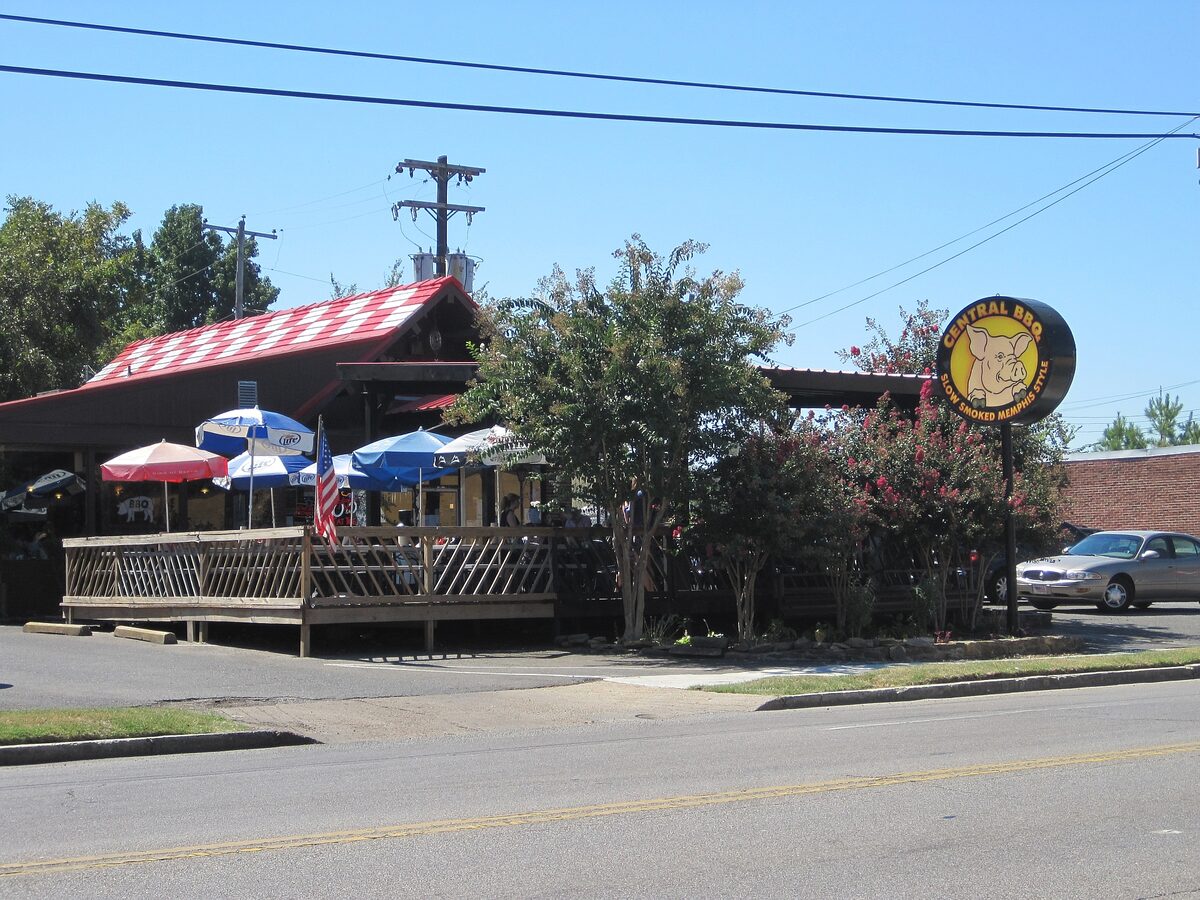 Central BBQ with its pig sign, outdoor deck and umbrellas